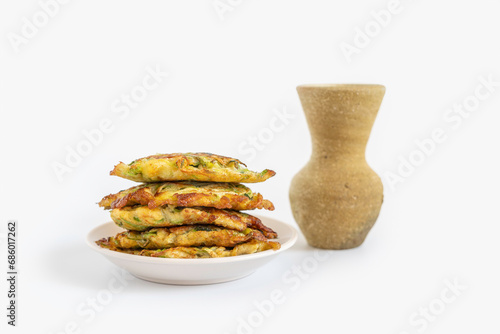 Zucchini fritters or latkes for Jewish holiday Hanukkah on white background. photo