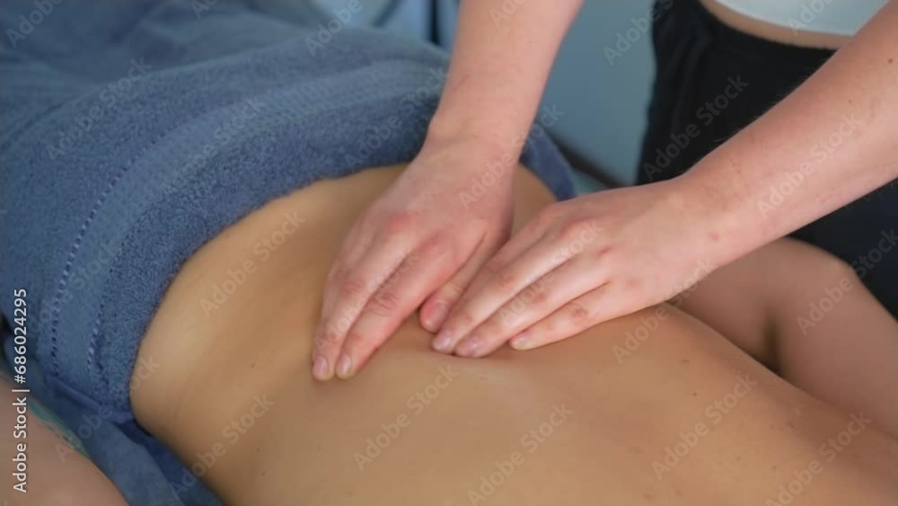 Female masseuse does back massage to young unrecognizable woman in spa centre, close-up. Attractive female relaxing at spa center getting body rejuvenating therapy Female masseuse does back massage to young unrecognizable woman in spa centre, close-up. Attractive female relaxing at spa center getting body rejuvenating therapy