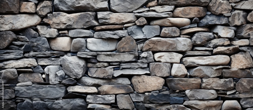 Textured stone wall with numerous rocks.