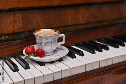 Wall Mural a cup of coffee on the piano keys