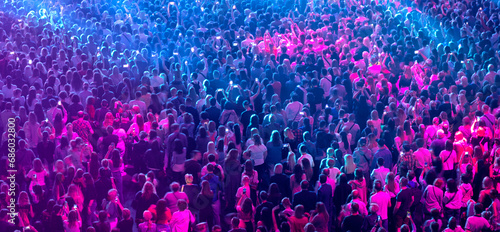 crowd of people at a concert in a huge concert hall