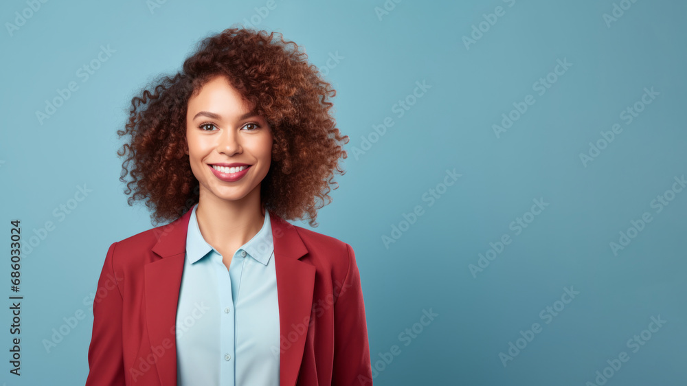 Poised woman, 20s, with red-brown curls in blue studio Poised woman, 20s, with red-brown curls in blue studio