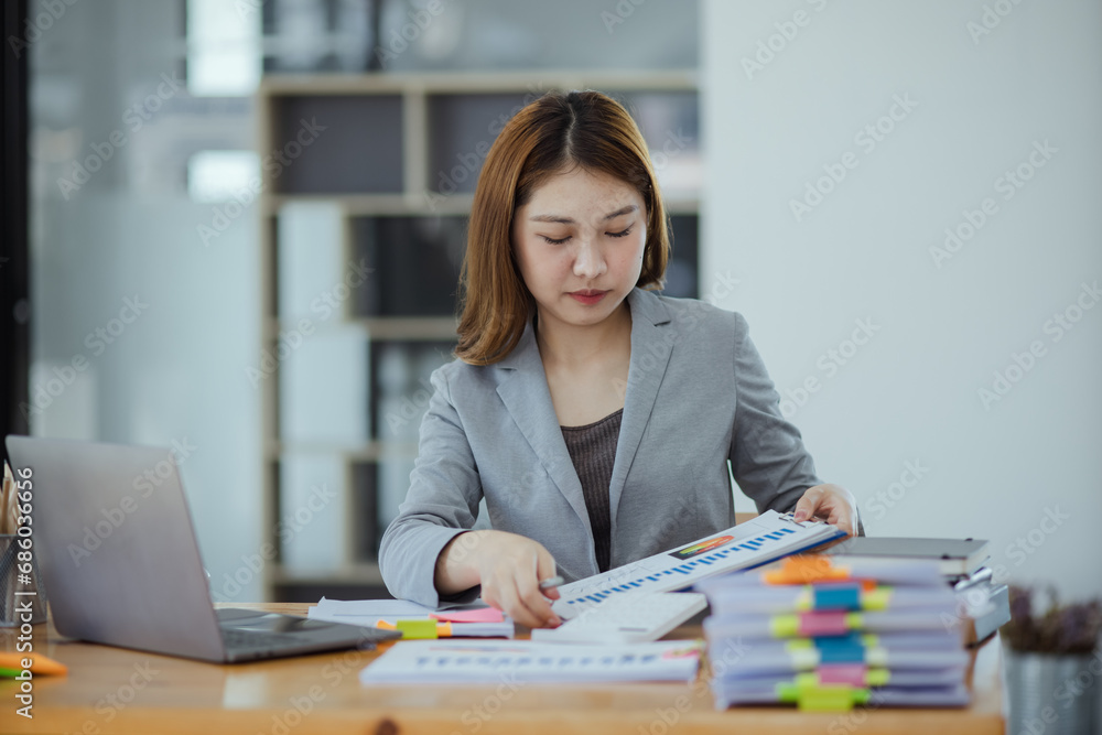 Asian businesswoman discuss new project investment plans and strategies for making business profits with laptop sitting at workplace in modern office. Asian businesswoman discuss new project investment plans and strategies for making business profits with laptop sitting at workplace in modern office.