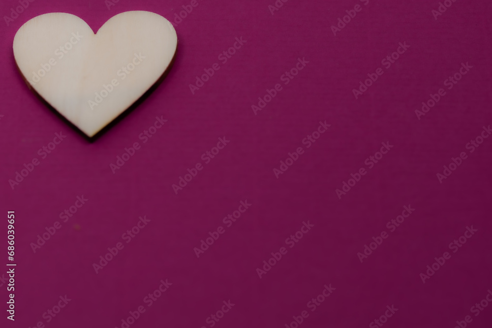 Fototapeta premium small wooden heart on purple background,saint valentine's day,valentine's day background,purple background with heart