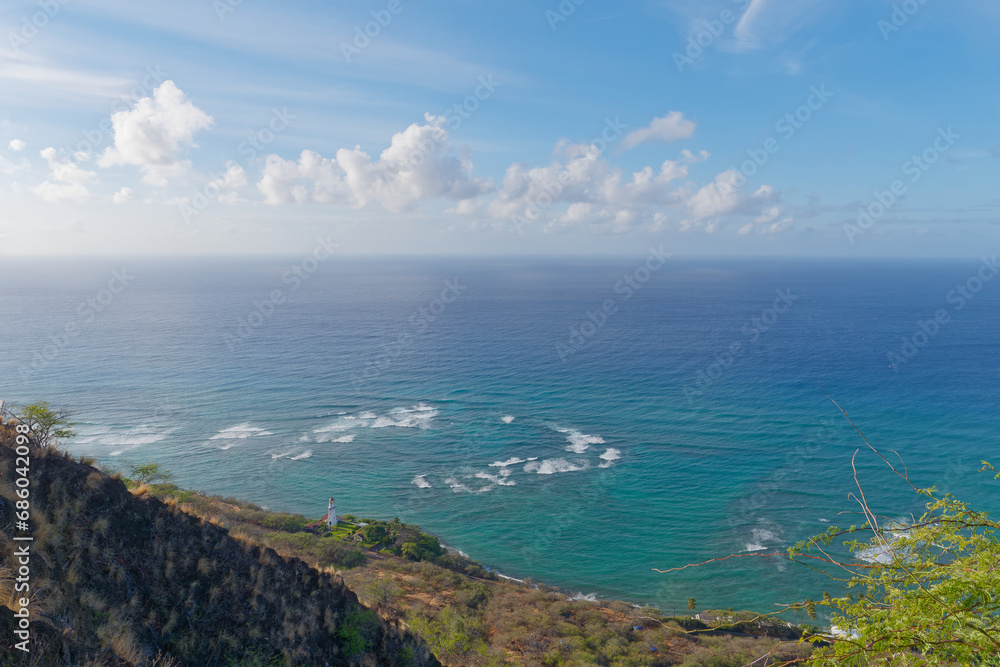 Peaceful view of the sky, ocean, and Diamond Head Lighthouse in the distance from the Diamond Head hike, Oahu, Hawaii