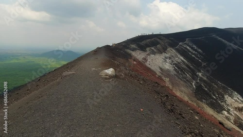 POV walking on ash rim of Cerro Nego Volcano crater in Nicaragua photo
