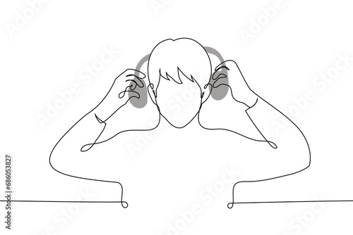 man stands raising his on-ear headphones or putting them on - one line art vector. concept taking off or putting on headphones