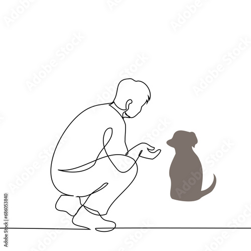 man squatted down and extended his hand to the dog - one line art vector. concept dog owner, dog walker, dog sitter