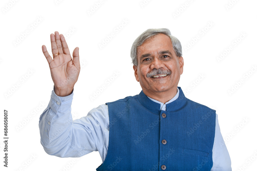 Senior Indian businessman or executive in a light blue shirt and dark sleveless jacket waving Senior Indian businessman or executive in a light blue shirt and dark sleveless jacket waving