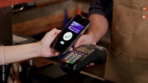 Unrecognizable hands of customer female using credit card to pay for goods or a cup of coffee in eatery cafe shop with cash register machine, technology cashless wireless transaction payment lifestyle