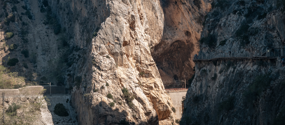 Fototapeta premium Tourists Exploring the Majestic Caminito del Rey Canyons and Trails