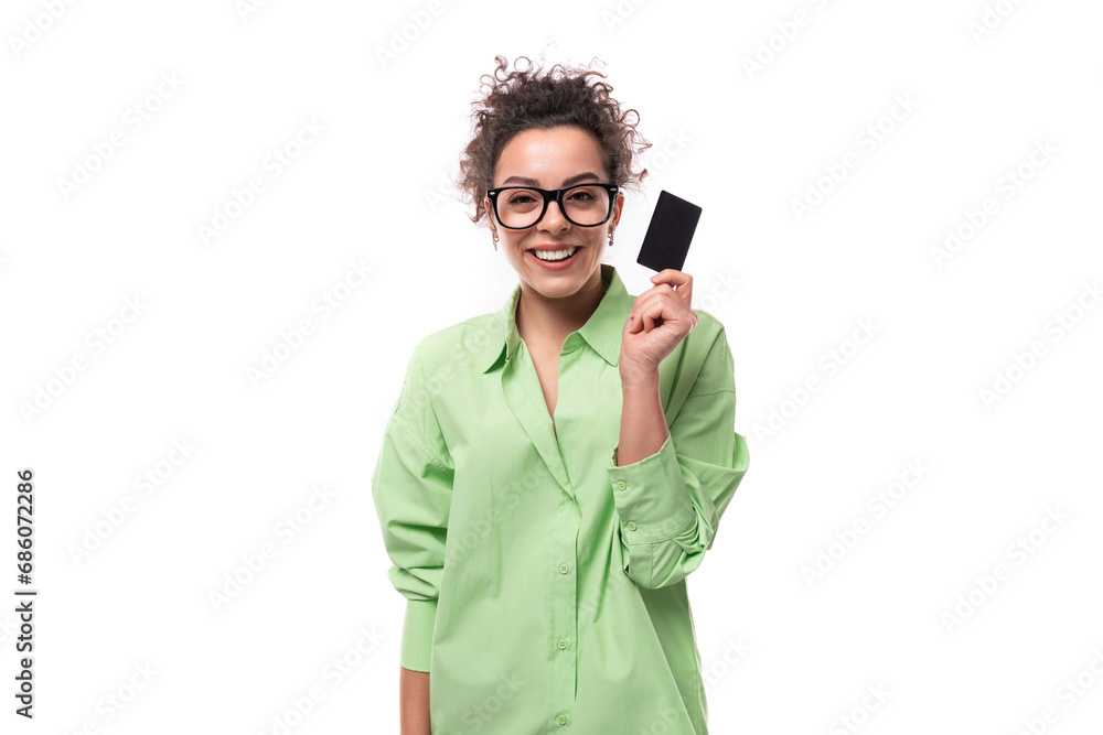 pretty young brunette curly woman in glasses dressed in a green shirt holding a plastic card mockup pretty young brunette curly woman in glasses dressed in a green shirt holding a plastic card mockup