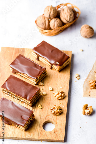 Gerbeaud Cake. Zserbo. Traditional Hungarian multi-layer cake with plum jam, nuts and covered with chocolate glaze
