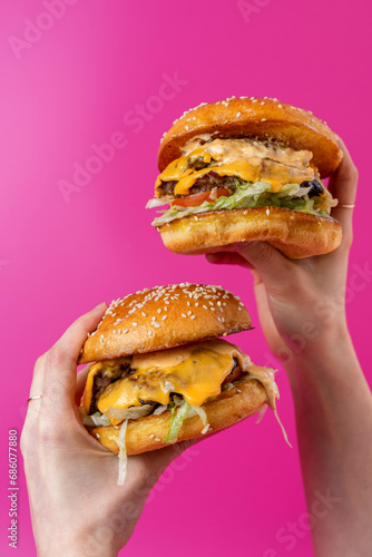 Two Double Beef Burgers Stacked With Melted Cheese Dripping On Hot Pink Background, Editorial Bold Creative Colour
