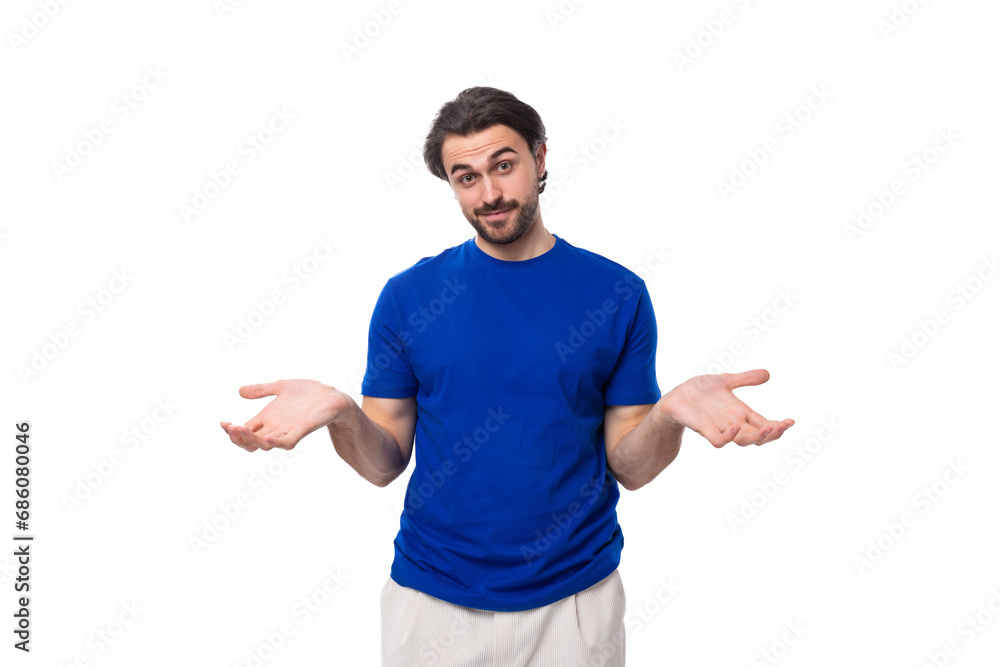 young brunette man with a beard dressed in a blue t-shirt thinks about solving problems on a white background young brunette man with a beard dressed in a blue t-shirt thinks about solving problems on a white background