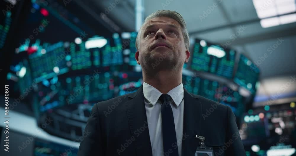 Portrait of a Handsome Adult Stock Exchange Broker Working in the Hall, Monitoring Real-Time Stocks Data, Analyzing Commodities and Exchange Market Charts. Professional Investment Agent in Office Portrait of a Handsome Adult Stock Exchange Broker Working in the Hall, Monitoring Real-Time Stocks Data, Analyzing Commodities and Exchange Market Charts. Professional Investment Agent in Office
