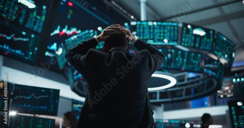 Stressed Stock Exchange Trader Can't Apprehend a Sudden Stock Market Collapse. Financial Crisis Concept with Stock Broker Saddened by Negative Ticker Information, Red Graphs and Real-Time Data photo