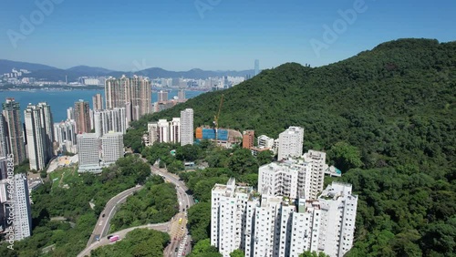 Pok Fu Lam Road, mixed forested and dense build areas on mountain slopes, connecting Aberdeen, Ap Lei Chau, Central and Sheung Wan in Hong Kong. Aerial drone Skyview from Kennedy Town to Cyberport San photo