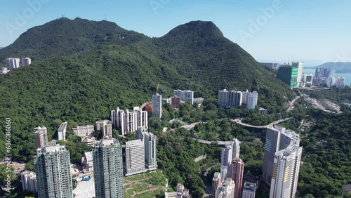 Pok Fu Lam Road, mixed forested and dense build areas on mountain slopes, connecting Aberdeen, Ap Lei Chau, Central and Sheung Wan in Hong Kong. Aerial drone Skyview from Kennedy Town to Cyberport San photo