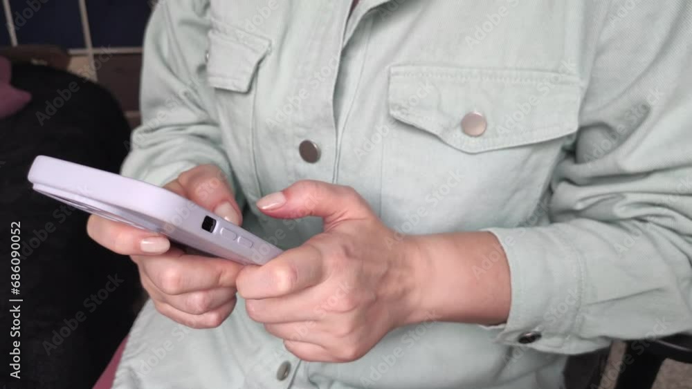 a young girl is playing a smartphone game hitting the camera a young girl is playing a smartphone game hitting the camera