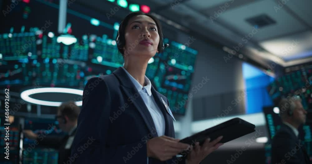 Smart Stock Exchange Agent Having a Conversation on a Phone Call, Suggesting a Client to Invest in a New Successful Startup That Just Went Public Through an IPO. Portrait of a Beautiful Asian Female Smart Stock Exchange Agent Having a Conversation on a Phone Call, Suggesting a Client to Invest in a New Successful Startup That Just Went Public Through an IPO. Portrait of a Beautiful Asian Female
