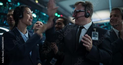 Group of Successful Stock Exchange Brokers Celebrating a Profitable Investment Bid on a Securities Market. Diverse Specialists and Asset Managers Clapping, Cheering, Giving High Fives to Team Members photo