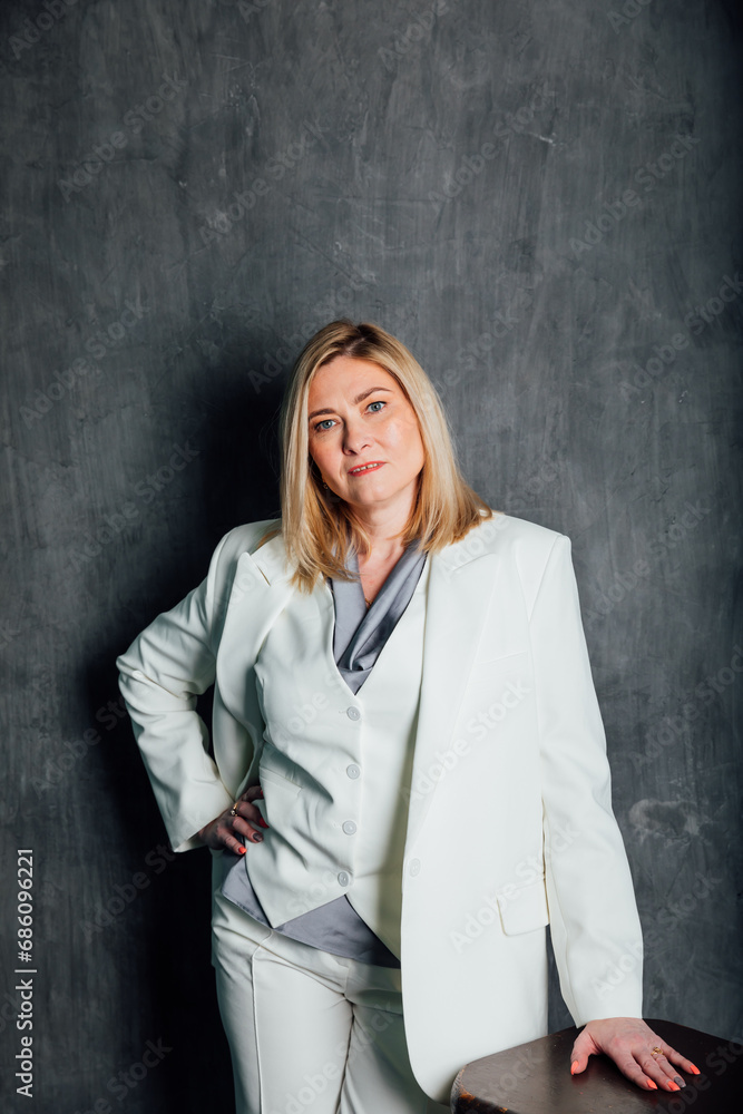 adult woman in white business suit in office adult woman in white business suit in office