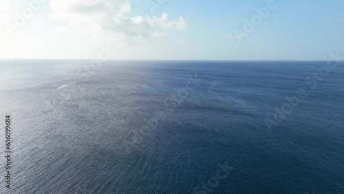 High angle overview of empty ocean sea as wind blows waves across surface, view to horizon photo
