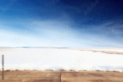 Wooden floor and snowdrift on blue sky background with copy space. High quality photo