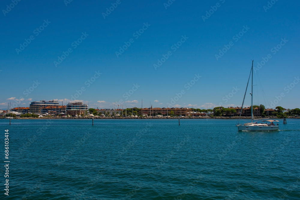 The coastal holiday resort town of Grado in Friuli-Venezia Giulia, north east Italy. Viewed from the Marano and Grado Lagoon in August