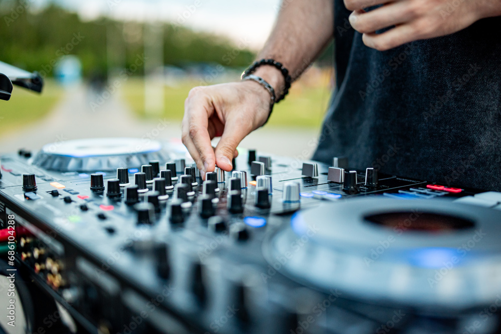 Fototapeta premium DJ Hands creating and regulating music on dj console mixer in concert