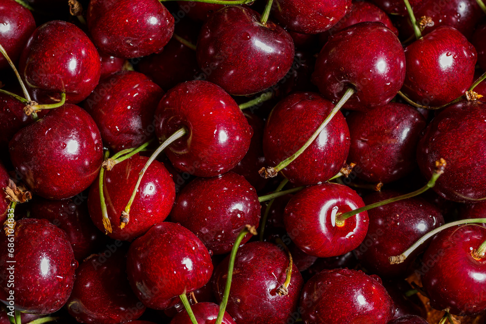 Cherry background.Close up of a bunch of bright red cherries shot from above. Cherry with drops. Food background. Cherry background.Close up of a bunch of bright red cherries shot from above. Cherry with drops. Food background.