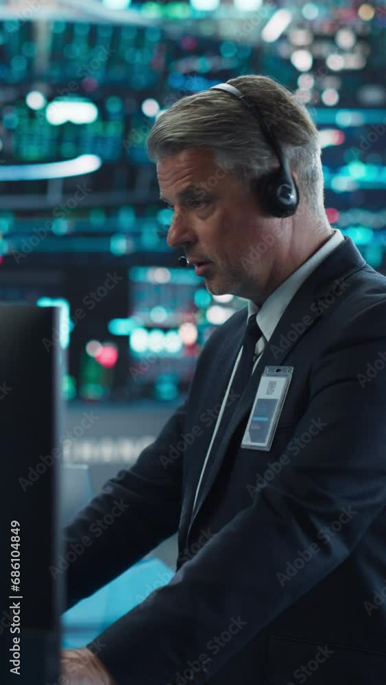 Vertical Screen: Productive Stock Exchange Broker Working on a Computer with Real-Time Stocks, Commodities and Exchange Market Charts. Professional Investor Talking on a Call with Business Partners Vertical Screen: Productive Stock Exchange Broker Working on a Computer with Real-Time Stocks, Commodities and Exchange Market Charts. Professional Investor Talking on a Call with Business Partners
