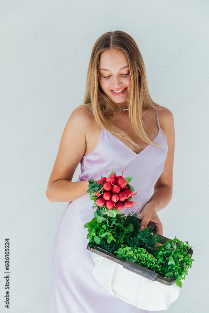 woman holding clutch with vegetables for eating woman holding clutch with vegetables for eating