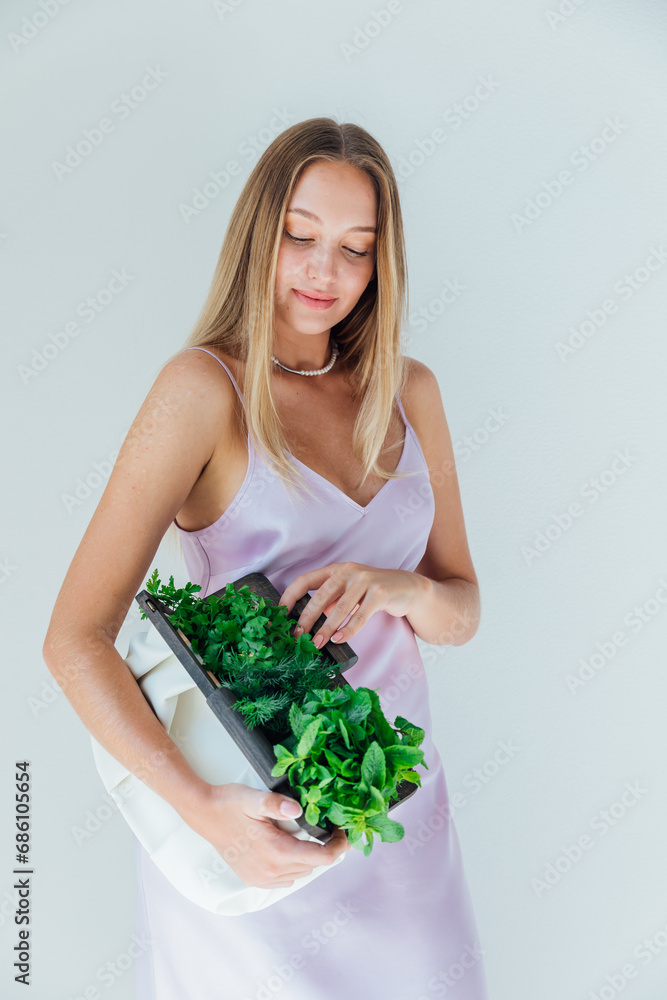 woman holding clutch with vegetables for eating woman holding clutch with vegetables for eating