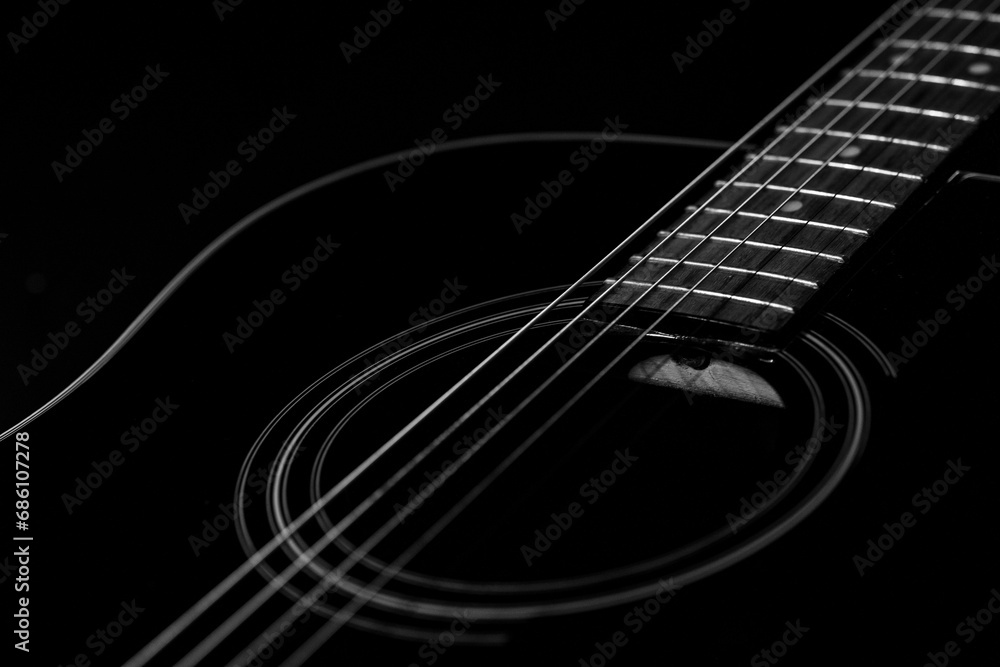 Fototapeta premium Closeup shot of details on a glossy black acoustic guitar