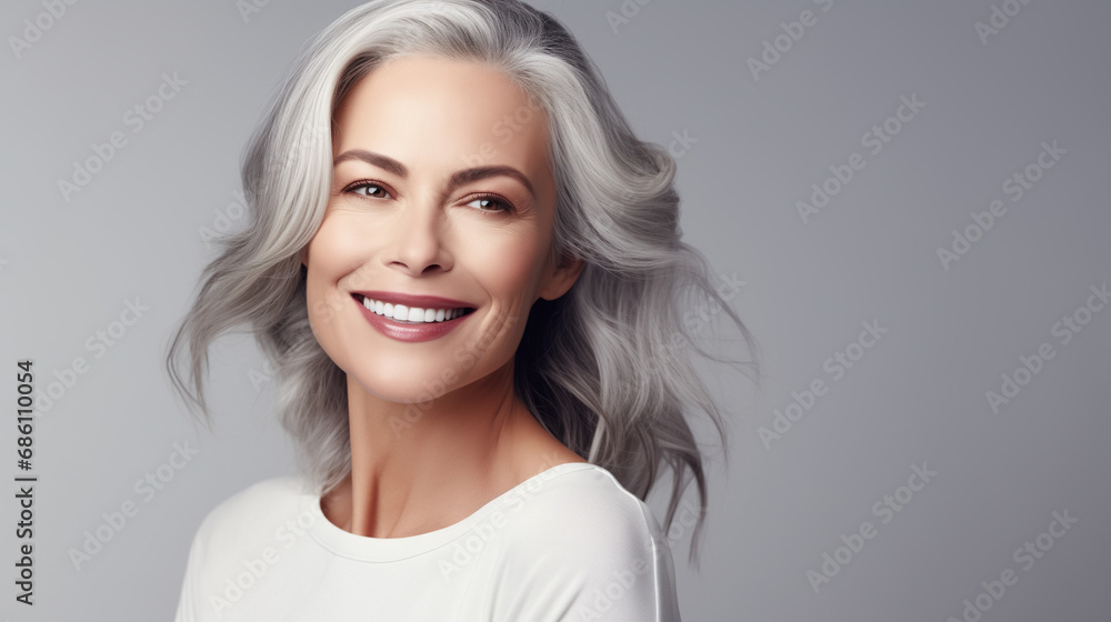 Adult woman with smooth healthy face skin. Beautiful aging mature woman with gray hair and happy smiling touch face. Beauty and cosmetics skincare advertising concept Adult woman with smooth healthy face skin. Beautiful aging mature woman with gray hair and happy smiling touch face. Beauty and cosmetics skincare advertising concept