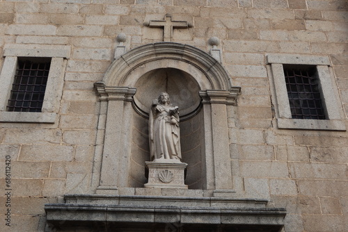 Cebreros, Avila, Spain, November 28, 2023: Sculpture of Santiago over the main door of the Santiago Apostol Church, 16th century, in the town of Cebreros, Avila, Spain photo