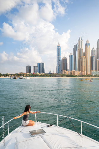 Photography Woman Enjoying a Sunset Yacht Ride in Dubai Marina Harbor in the UAE