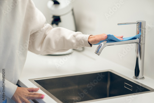 Close up of a female cleaning in the kitchen