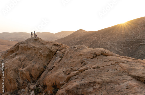 Rear View of Group of Persons at the Top of a Volcanic Mountain Watching the Sunset.Canary Island