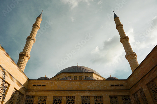 Islamic mosque in Turkey - Akdeniz University mosque in Antalya - two minarets with cloudy sky photo