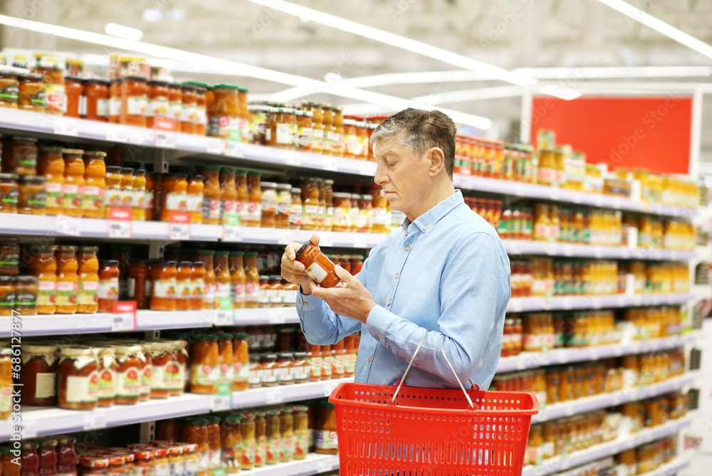 elderly man choosing groceries in a supermarket