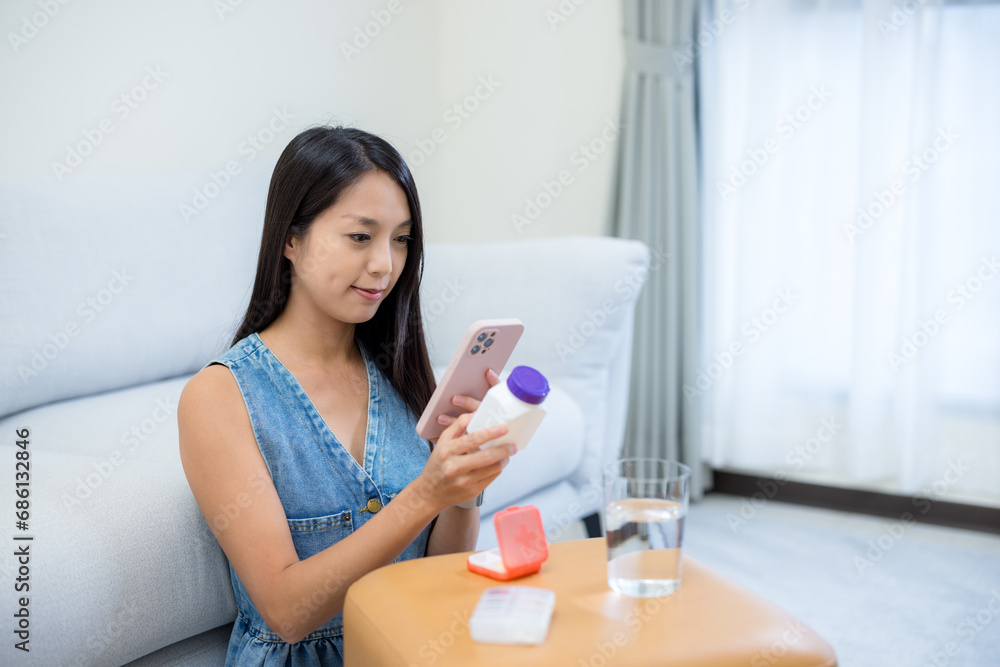 Woman check the medicine on cellphone at home Woman check the medicine on cellphone at home