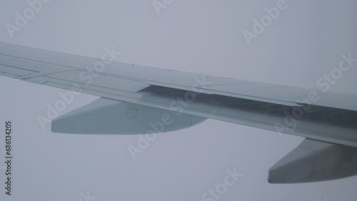 Turbulent Flight with Snow and Rain: Adverse Weather Conditions During Air Travel in 4k slow motion 60fps