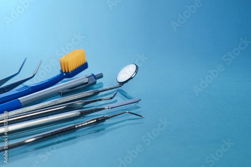   ollection of dental tools isolated on blue background