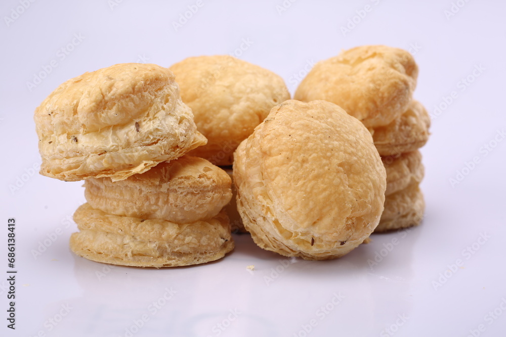 Macron shaped salted khari on isolated white background. Indian Salty Snack. High Resolution Macron shaped salted khari on isolated white background. Indian Salty Snack. High Resolution