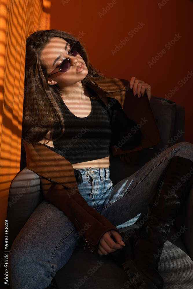 Beautiful slender brunette woman sun on orange Beautiful slender brunette woman sun on orange