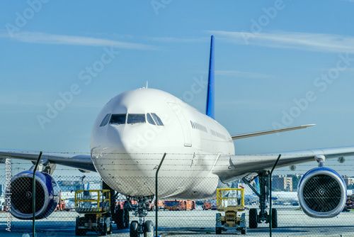An airplane loads on the runway receiving inspection, cleaning and fuel photo