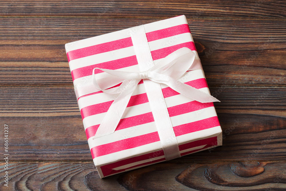 wrapped Christmas or other holiday handmade gift box in color paper with ribbon on colored background. Present box, decoration of gift on colored table, top view with copy space wrapped Christmas or other holiday handmade gift box in color paper with ribbon on colored background. Present box, decoration of gift on colored table, top view with copy space